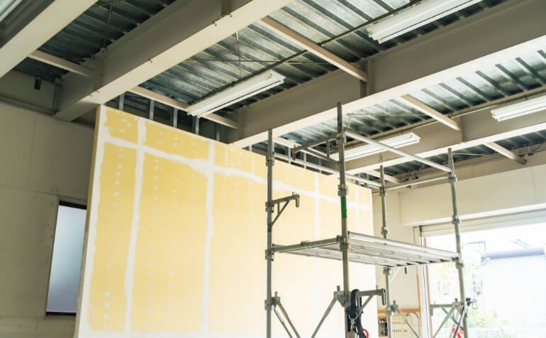 内装工事のため、足場を作り壁面パネルを設置したフロアの内装